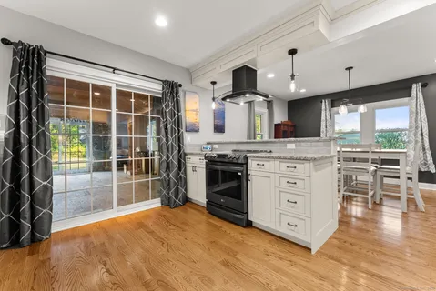 a kitchen with stainless steel appliances a stove top oven and a refrigerator