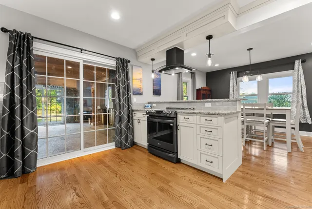 a kitchen with stainless steel appliances a stove top oven and a refrigerator
