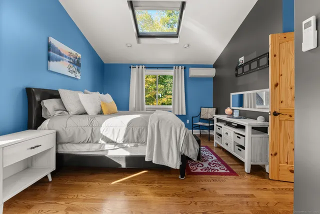 a view of a hallway view with wooden floor and furniture