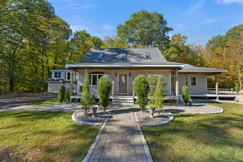 a view of house with swimming pool and porch with furniture