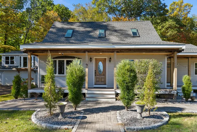 a front view of a house with garden