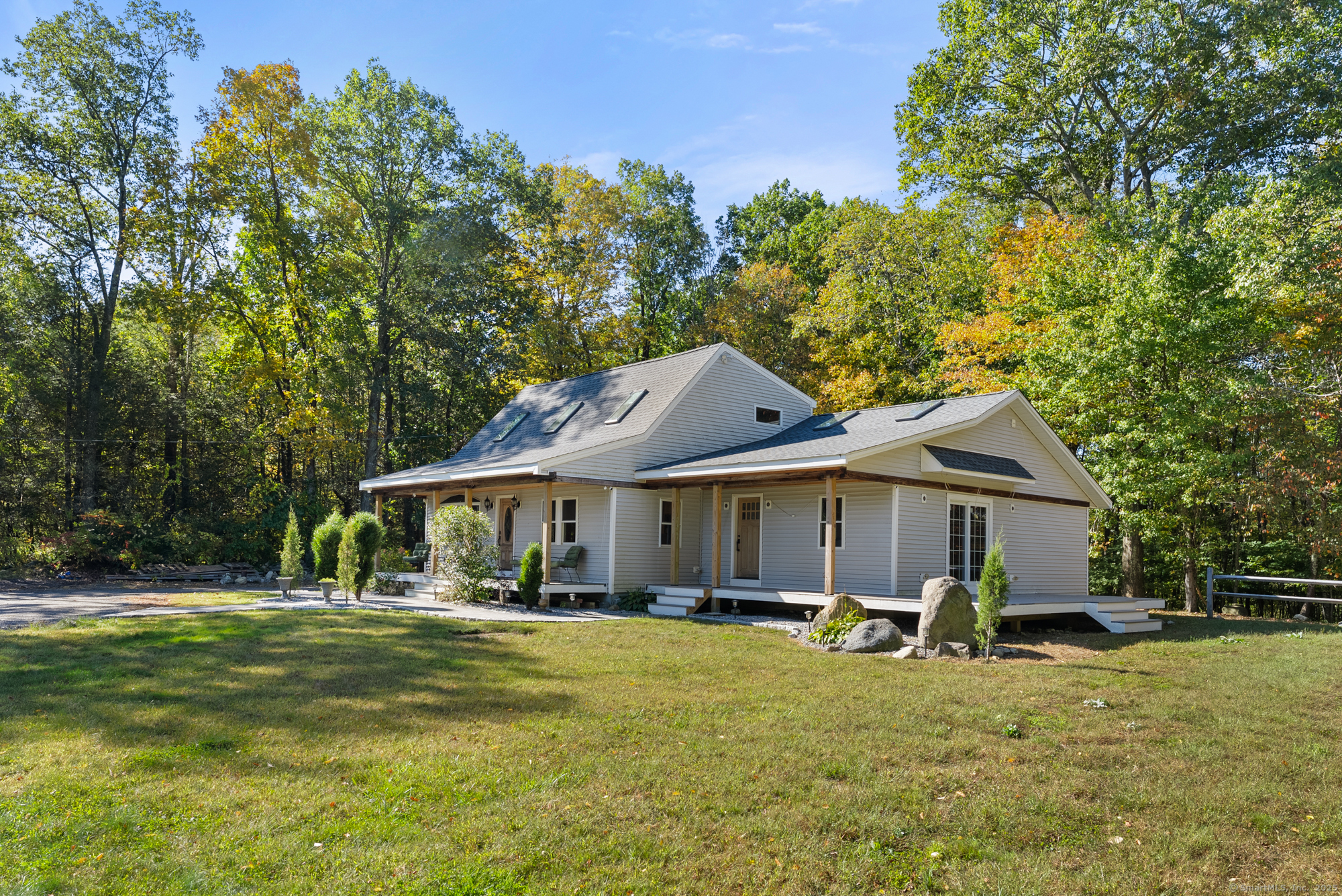 44 Bantam Lake Heights Morris, CT 06763 - Photo 9 of 40 a front view of a house with a yard table and chairs