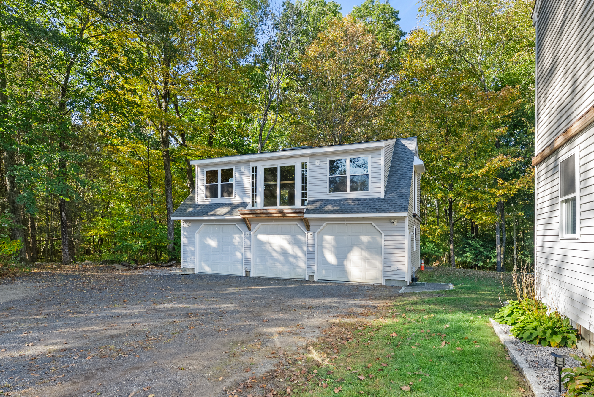 44 Bantam Lake Heights Morris, CT 06763 - Photo 10 of 40 a front view of a house with a garden and tree