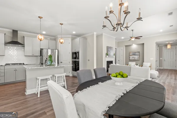 a living room with kitchen island furniture and a chandelier