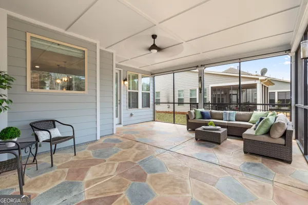 a living room with furniture and large windows