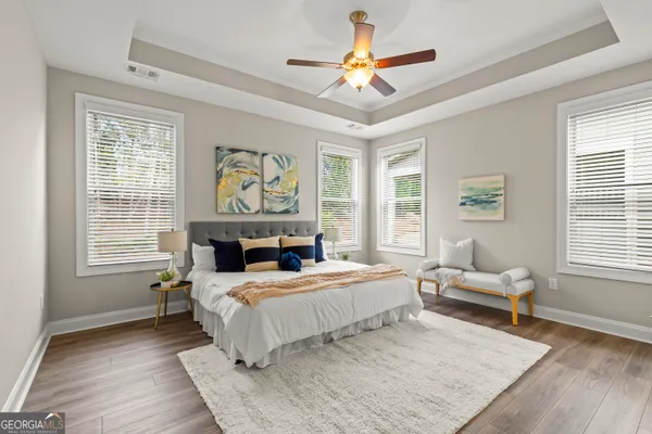 a bedroom with a bed and a chandelier