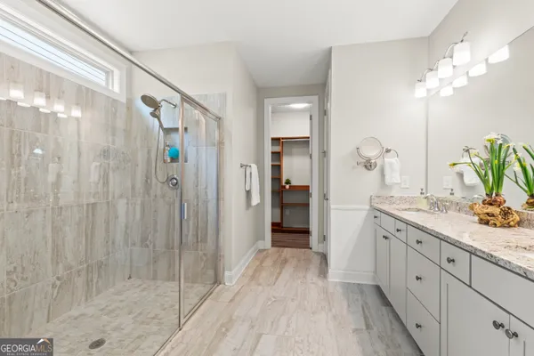 a bathroom with a double vanity sink and a mirror