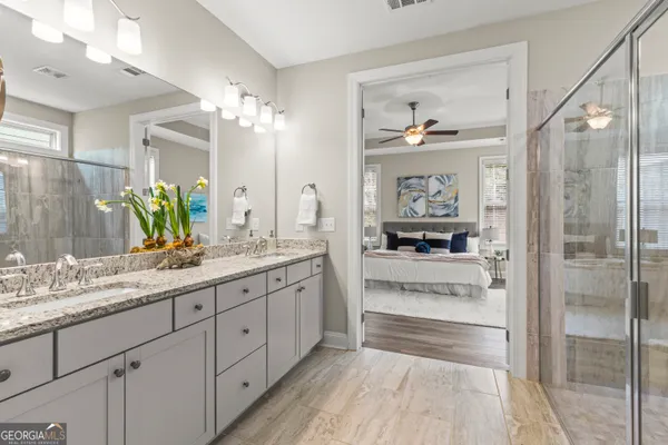 a view of an empty room with a kitchen and wooden floor