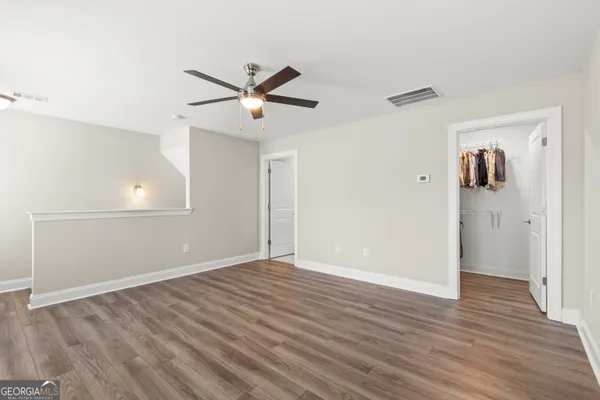 a bathroom with a granite countertop sink toilet a mirror and shower