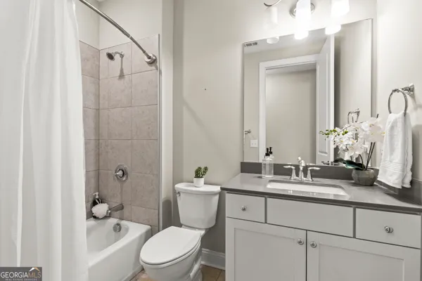 a view of walk in closet with clothes