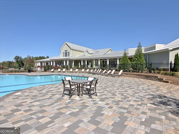 a view of a patio with table and chairs next to a yard