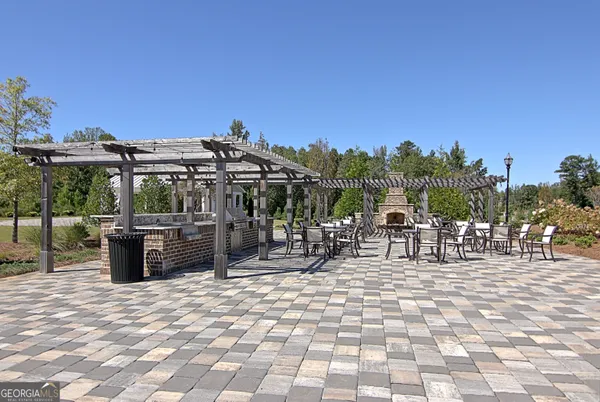 a front view of a house with a yard table and chairs