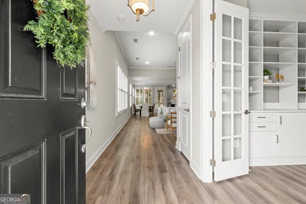 a view of a hallway with wooden floor and staircase