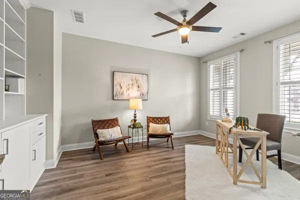 a living room with furniture and a wooden floor