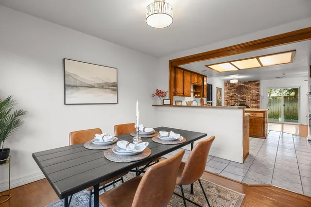 a dining room with furniture and wooden floor