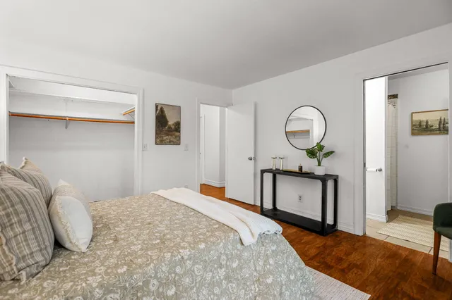 a bedroom with a bed and a mirror