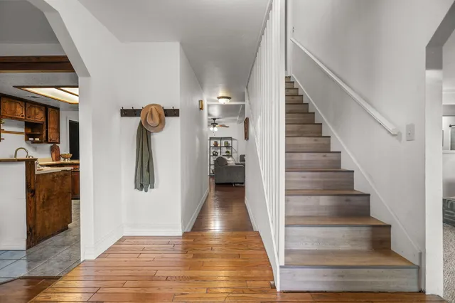 a view of entryway and hall with wooden floor