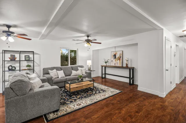 a living room with furniture and a chandelier