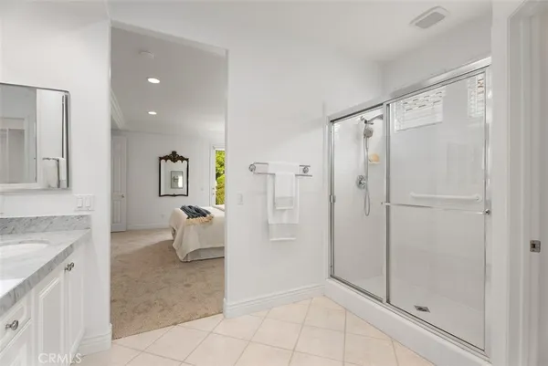 a bathroom with a granite countertop sink a toilet and shower
