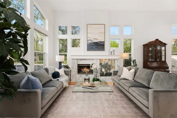 a living room with furniture and a fireplace