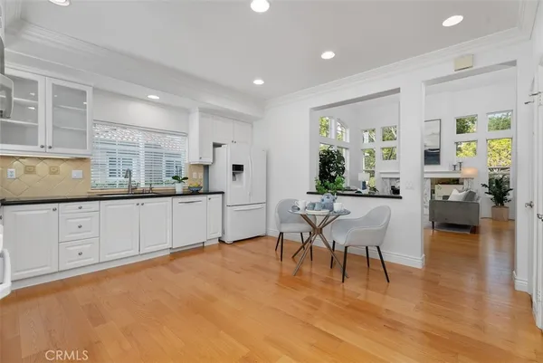 a living room with kitchen island furniture and a kitchen view