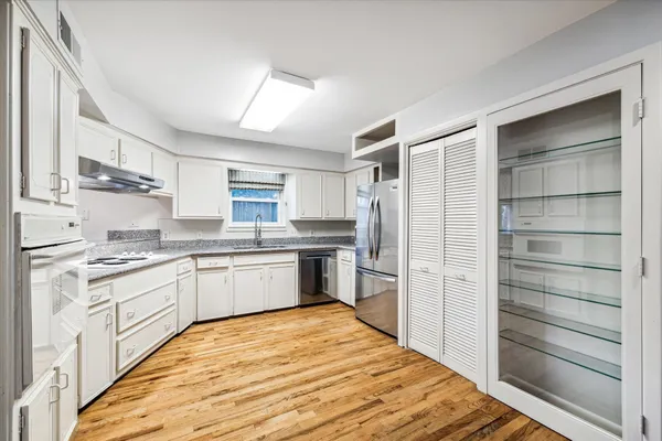 a kitchen with a refrigerator stove and sink