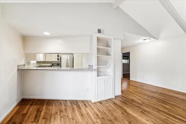 a view of kitchen with wooden floor and electronic appliances
