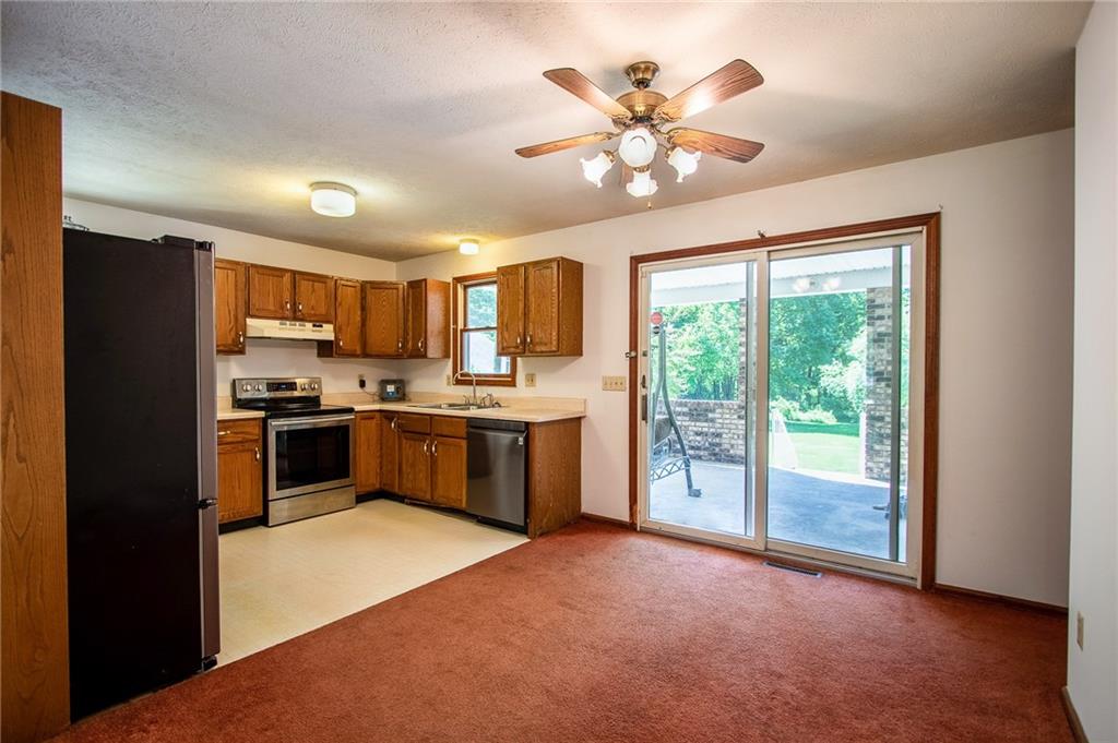 186 Riemer Road Sarver, PA 16055 - Photo 5 of 25 a kitchen with stainless steel appliances a refrigerator sink stove microwave and cabinets