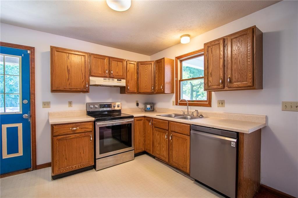 186 Riemer Road Sarver, PA 16055 - Photo 7 of 25 a kitchen with a sink stove top oven and cabinets