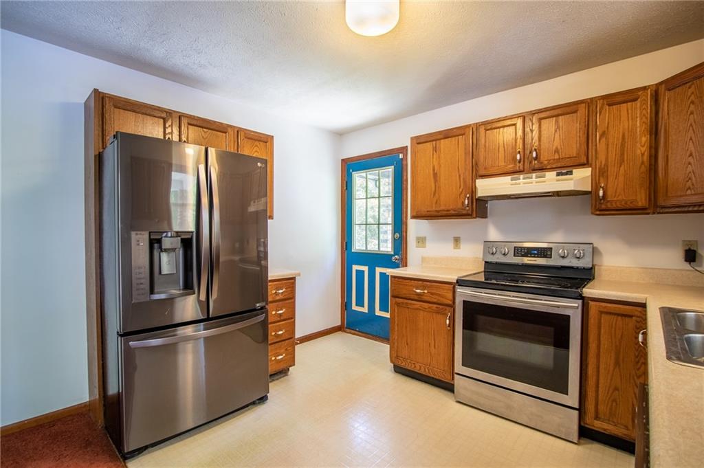 186 Riemer Road Sarver, PA 16055 - Photo 8 of 25 a kitchen with stainless steel appliances granite countertop a refrigerator stove and sink