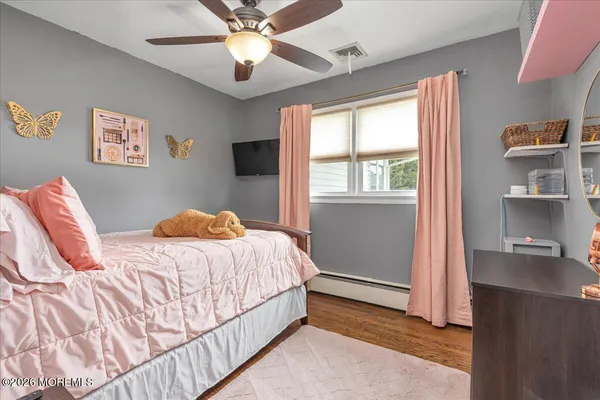 a spacious bedroom with a bed and a chandelier