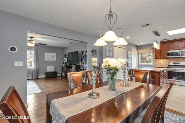 a kitchen with granite countertop a refrigerator stove microwave and cabinets