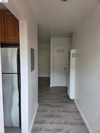 a room with wooden floor and bathroom