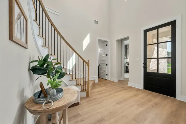 a view of an entryway with wooden floor