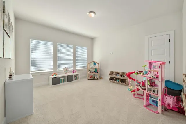 a bedroom with furniture and a large window