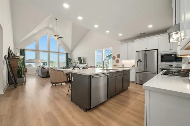 a kitchen with sink cabinets and wooden floor
