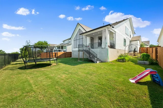 a view of a house with a yard and sitting area