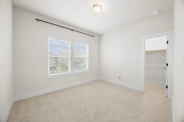 a bathroom with a sink a toilet and shower a mirror