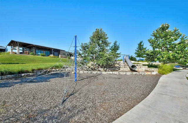 a view of a house with a yard and a street