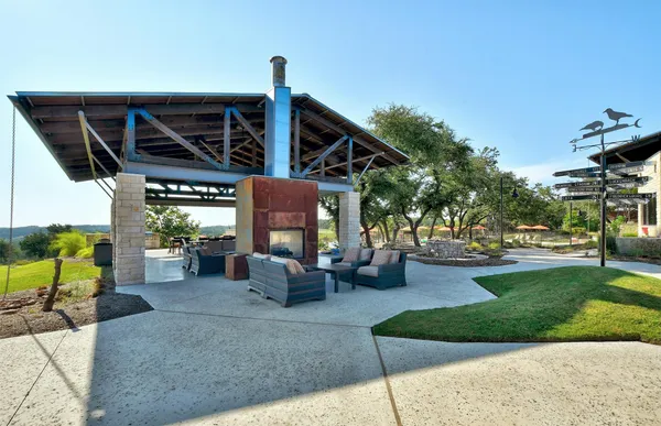 a view of a swimming pool with a yard and sitting area