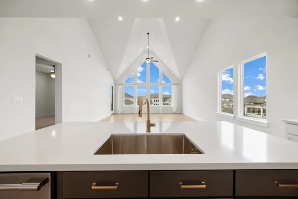 a large kitchen with stainless steel appliances a refrigerator and a sink