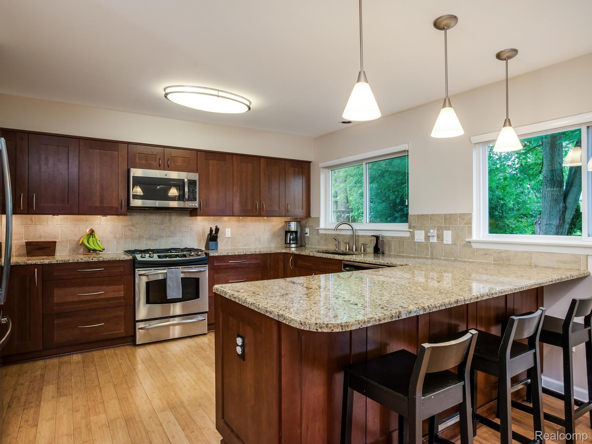 843 Dumont Place Rochester, MI 48307 - Photo 7 of 31 Modern kitchen with granite countertops, stainless steel appliances, and hardwood floors