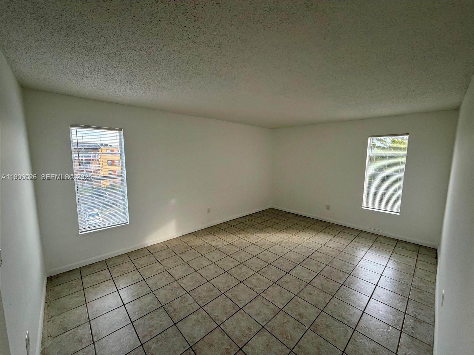 2800 Northwest 56th Avenue, Unit E401 Lauderhill, FL 33313 - Photo 2 of 6 an empty room with windows