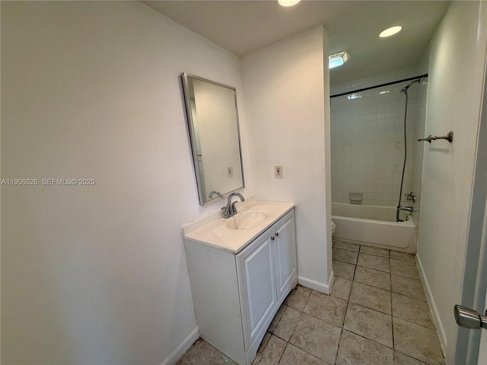 2800 Northwest 56th Avenue, Unit E401 Lauderhill, FL 33313 - Photo 3 of 6 a bathroom with a sink a toilet and shower
