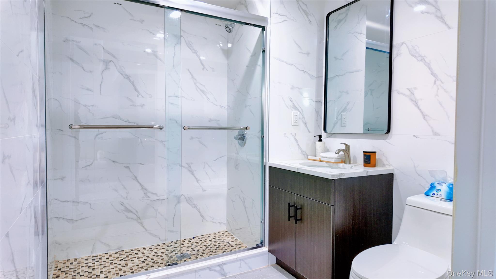 9730 64th Avenue, Unit 3C Queens, NY 11374 - Photo 3 of 5 Bathroom featuring vanity and a marble finish shower