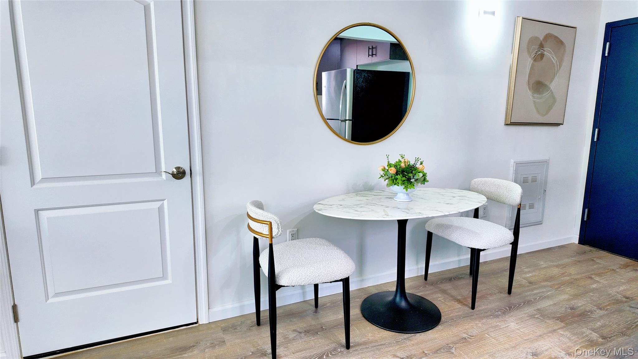 9730 64th Avenue, Unit 3C Queens, NY 11374 - Photo 5 of 5 Dining room with light wood-style floors and baseboards