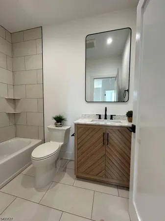 a bathroom with a sink a toilet and bathtub
