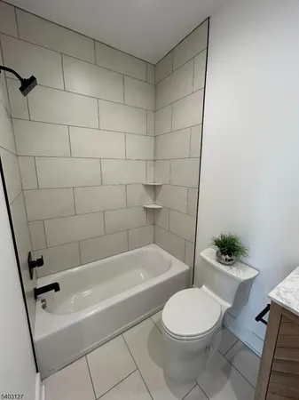 a bathroom with a toilet and bathtub