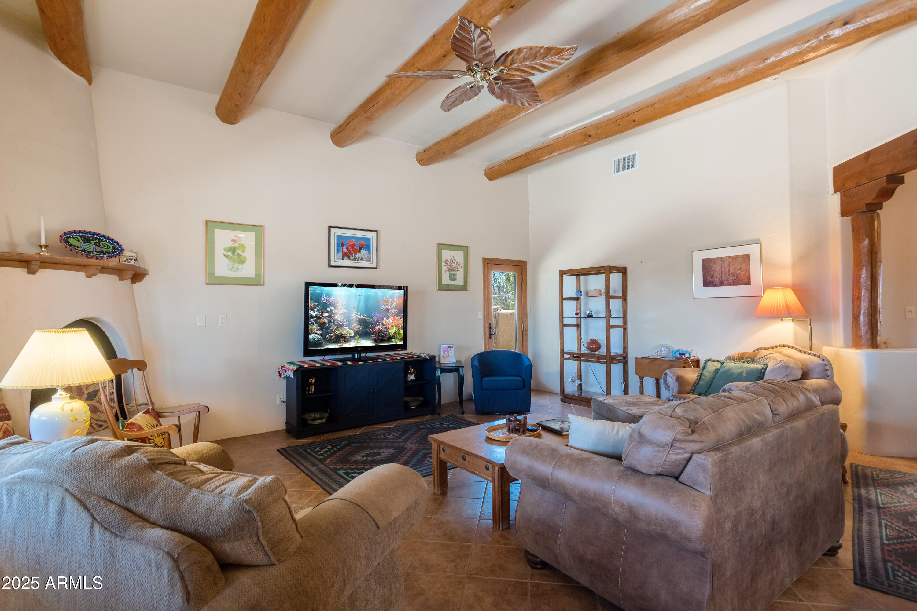 8765 South Airstrip Road Hereford, AZ 85615 - Photo 11 of 47 a living room with furniture and a flat screen tv