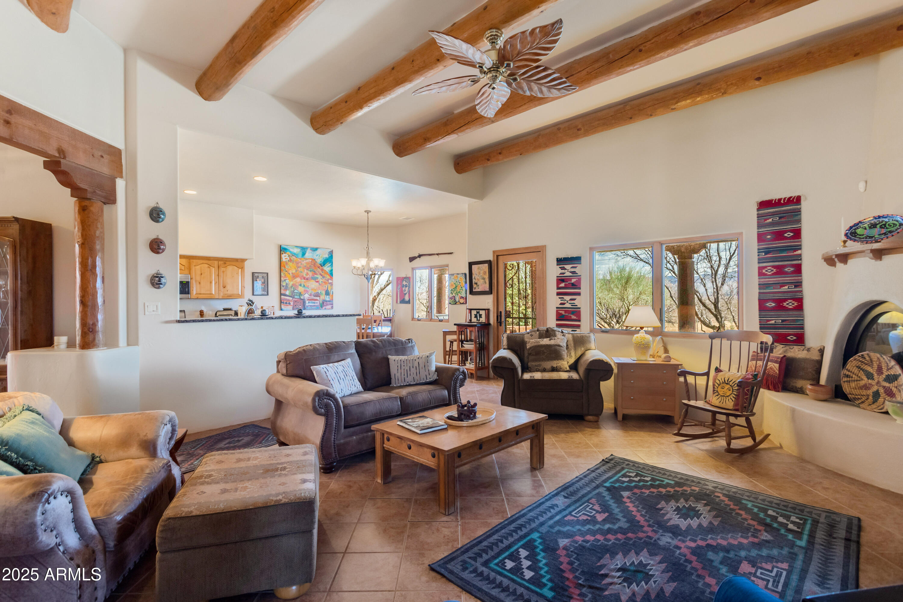 8765 South Airstrip Road Hereford, AZ 85615 - Photo 12 of 47 a living room with furniture a rug and a chandelier